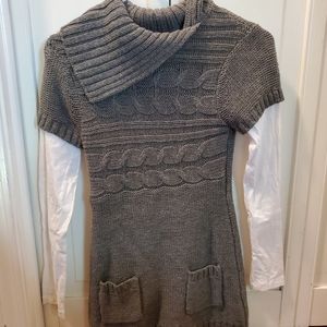 Grey sweater with white long sleeves attached to i